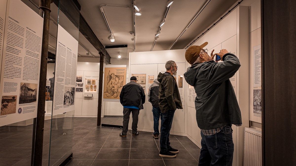 Members of the group inside the Szubin museum, reading the history panels of the new exhibition